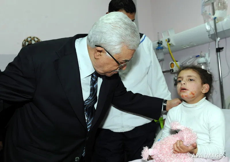 Palestinian President Mahmoud Abbas visits a Palestinian child, one of dozens of schoolchildren injured in a school bus accident, at a hospital in the West Bank city of Ramallah, Thursday, Feb. 16, 2012. A truck lost con...