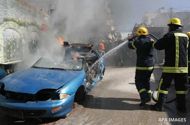 Palestinian firefighters douse a fire during an earthquake drill organised by the civil defence forces in the West Bank city of Jenin on February 16, 2012. Photo by Wagdi Eshtayah