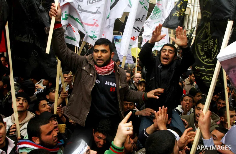 Islamic Jihad activists protest after the Friday noon prayer in support of Khader Adnan, a fellow Palestinian senior militant held in an Israeli prison without trial and who is on hunger strike since December 18, on Febr...