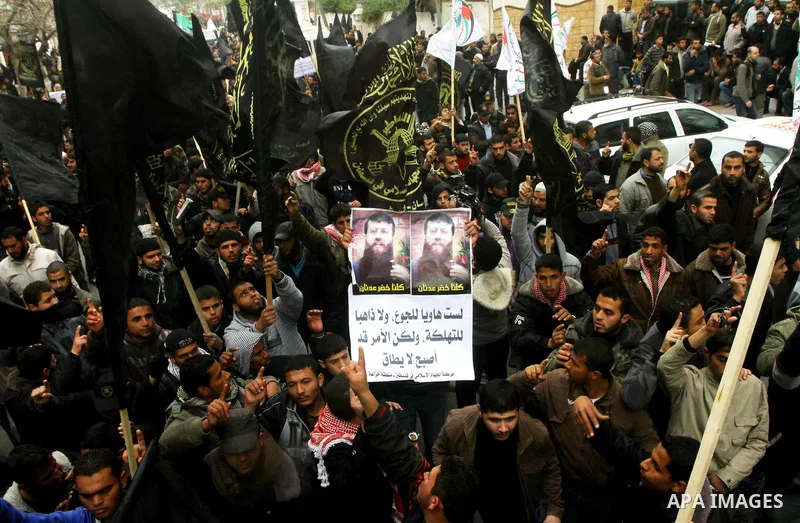 Islamic Jihad activists protest after the Friday noon prayer in support of Khader Adnan, a fellow Palestinian senior militant held in an Israeli prison without trial and who is on hunger strike since December 18, on Febr...