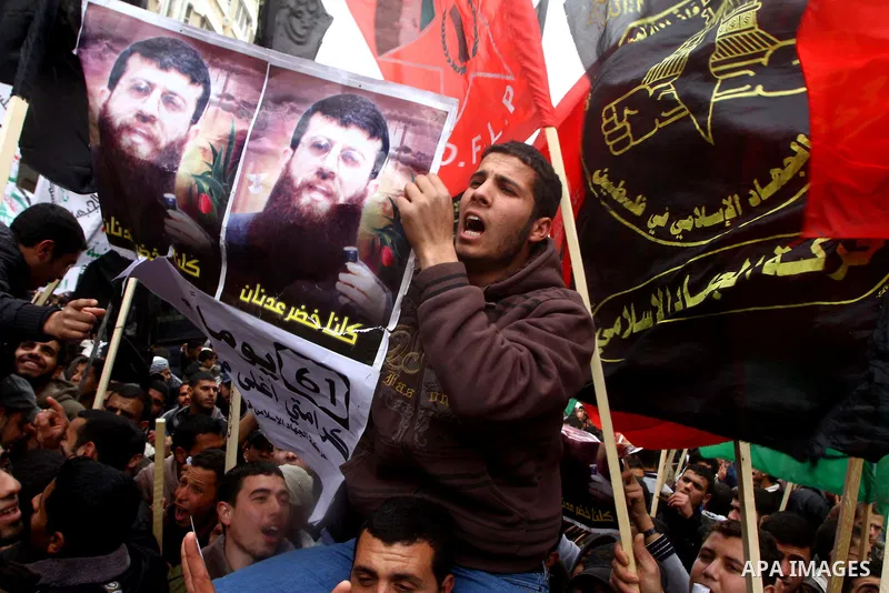Islamic Jihad activists protest after the Friday noon prayer in support of Khader Adnan, a fellow Palestinian senior militant held in an Israeli prison without trial and who is on hunger strike since December 18, on Febr...