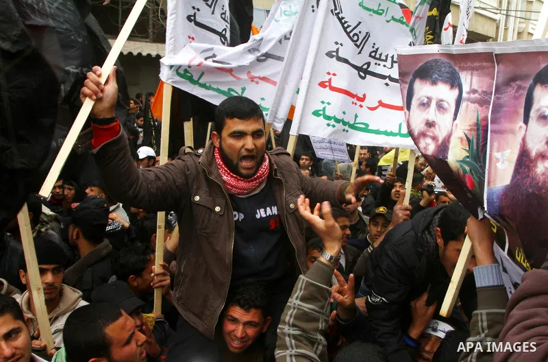 Islamic Jihad activists protest after the Friday noon prayer in support of Khader Adnan, a fellow Palestinian senior militant held in an Israeli prison without trial and who is on hunger strike since December 18, on Febr...