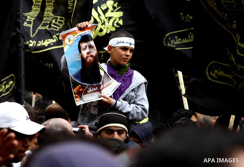 Islamic Jihad activists protest after the Friday noon prayer in support of Khader Adnan, a fellow Palestinian senior militant held in an Israeli prison without trial and who is on hunger strike since December 18, on Febr...