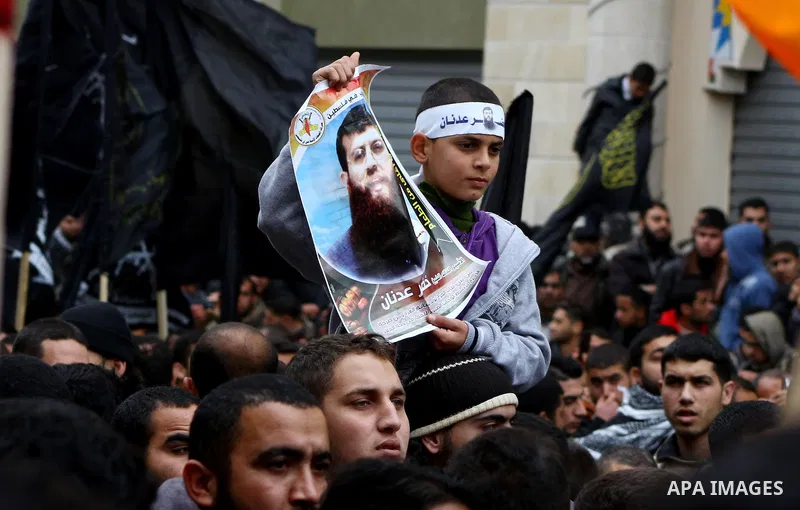 Islamic Jihad activists protest after the Friday noon prayer in support of Khader Adnan, a fellow Palestinian senior militant held in an Israeli prison without trial and who is on hunger strike since December 18, on Febr...