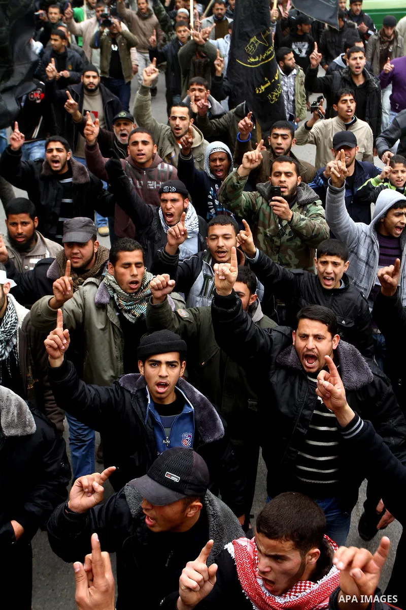 Islamic Jihad activists protest after the Friday noon prayer in support of Khader Adnan, a fellow Palestinian senior militant held in an Israeli prison without trial and who is on hunger strike since December 18, on Febr...
