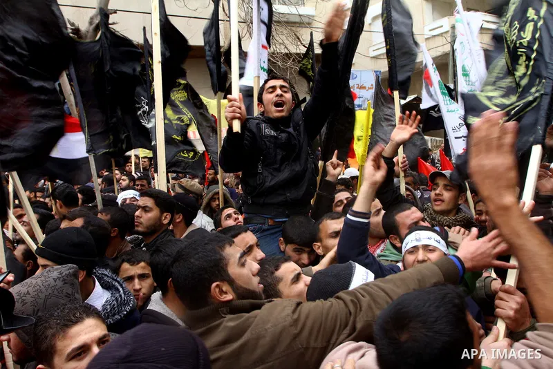 Islamic Jihad activists protest after the Friday noon prayer in support of Khader Adnan, a fellow Palestinian senior militant held in an Israeli prison without trial and who is on hunger strike since December 18, on Febr...