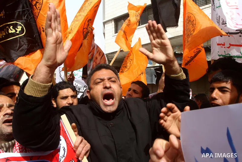 Islamic Jihad activists protest after the Friday noon prayer in support of Khader Adnan, a fellow Palestinian senior militant held in an Israeli prison without trial and who is on hunger strike since December 18, on Febr...