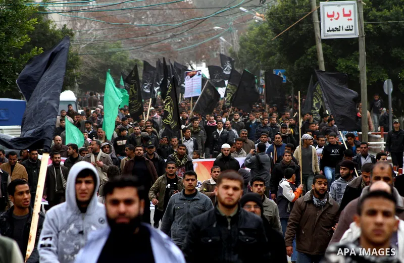 Islamic Jihad activists protest after the Friday noon prayer in support of Khader Adnan, a fellow Palestinian senior militant held in an Israeli prison without trial and who is on hunger strike since December 18, on Febr...