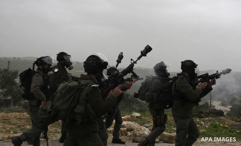 Israeli border police officers fire tear gas towards Palestinian demonstrators, during a protest in the village of Kufr Qaddum against the expansion of the nearby Jewish settlement of Kdumim, in the northern West Bank, F...