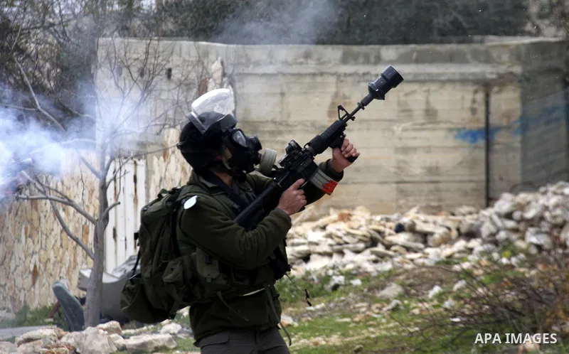 Israeli border police officers fire tear gas towards Palestinian demonstrators, during a protest in the village of Kufr Qaddum against the expansion of the nearby Jewish settlement of Kdumim, in the northern West Bank, F...