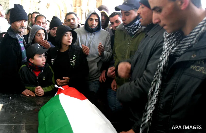 Palestinians take part in the funeral of a child, one of schoolchildren killed in a school bus accident, at Al-Aqsa mosque on Feb.17, 2012. A truck lost control in slick, rainy weather and barreled into a Palestinian sch...