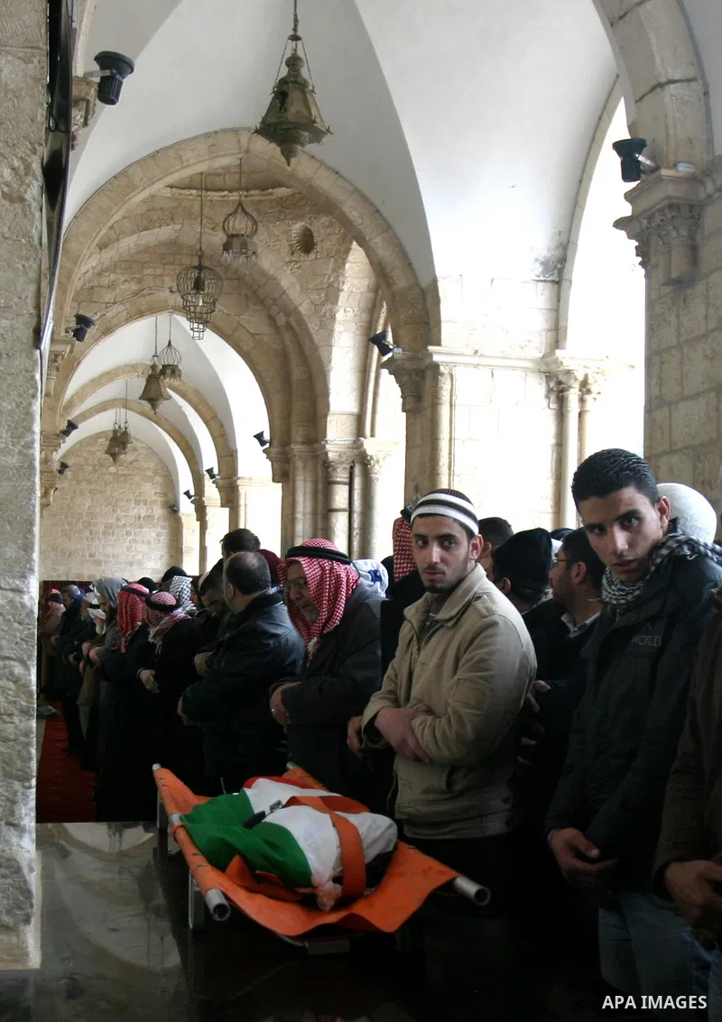 Palestinians take part in the funeral of a child, one of schoolchildren killed in a school bus accident, at Al-Aqsa mosque on Feb.17, 2012. A truck lost control in slick, rainy weather and barreled into a Palestinian sch...