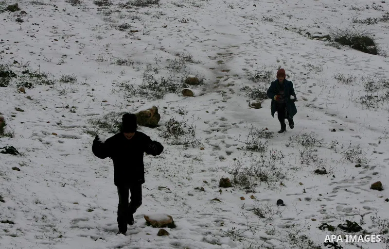 Palestinians play with snow in the West Bank city of Hebron on February 18, 2012. Photo by Mamoun Wazwaz