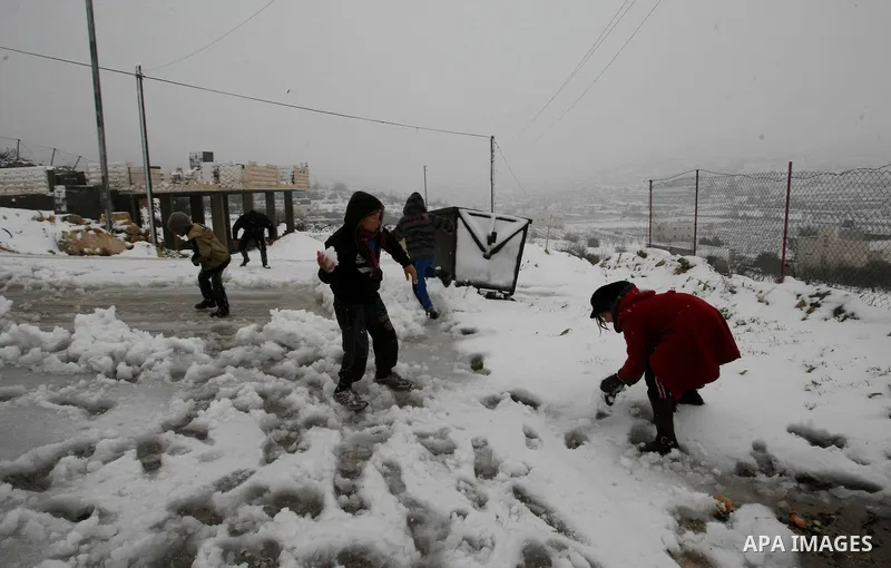 Palestinians play with snow in the West Bank city of Hebron on February 18, 2012. Photo by Mamoun Wazwaz