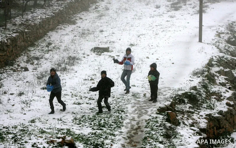 Palestinians play with snow in the West Bank city of Hebron on February 18, 2012. Photo by Mamoun Wazwaz