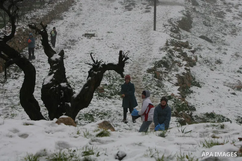 Palestinians play with snow in the West Bank city of Hebron on February 18, 2012. Photo by Mamoun Wazwaz