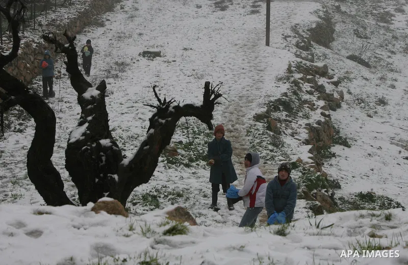 Palestinians play with snow in the West Bank city of Hebron on February 18, 2012. Photo by Mamoun Wazwaz