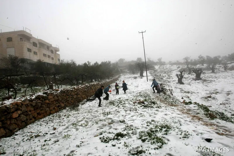 Palestinians play with snow in the West Bank city of Hebron on February 18, 2012. Photo by Mamoun Wazwaz