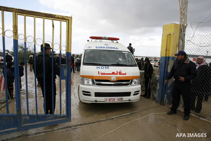 Palestinians attend a rally in front of the Rafah border crossing with Egypt on February 18, 2012 during a sit-in by dozens of emergency crews and ambulance workers demanding Egypt provide the Gaza Strip with electricity...