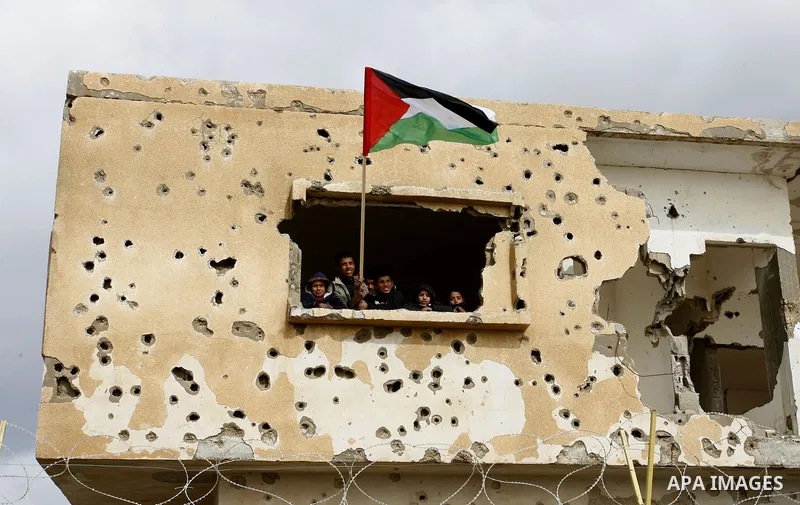 Palestinians attend a rally in front of the Rafah border crossing with Egypt on February 18, 2012 during a sit-in by dozens of emergency crews and ambulance workers demanding Egypt provide the Gaza Strip with electricity...