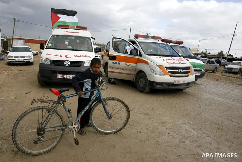 Palestinians attend a rally in front of the Rafah border crossing with Egypt on February 18, 2012 during a sit-in by dozens of emergency crews and ambulance workers demanding Egypt provide the Gaza Strip with electricity...