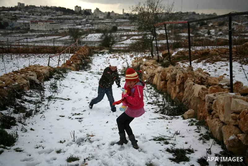 Palestinians play with snow in the West Bank city of Hebron on February 18, 2012. Photo by Mamoun Wazwaz