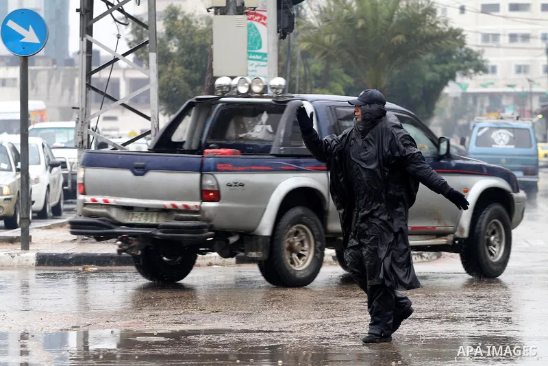 Palestinian police man organize the traffic during the heavy rain of the winter, in the Gaza City, Feb.19, 2012. Photo by Mohammed Asad