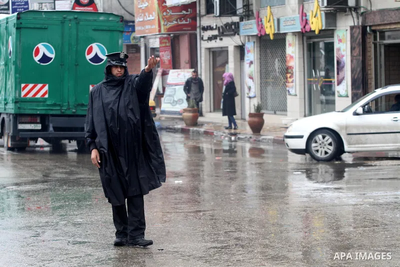 Palestinian police man organize the traffic during the heavy rain of the winter, in the Gaza City, Feb.19, 2012. Photo by Mohammed Asad