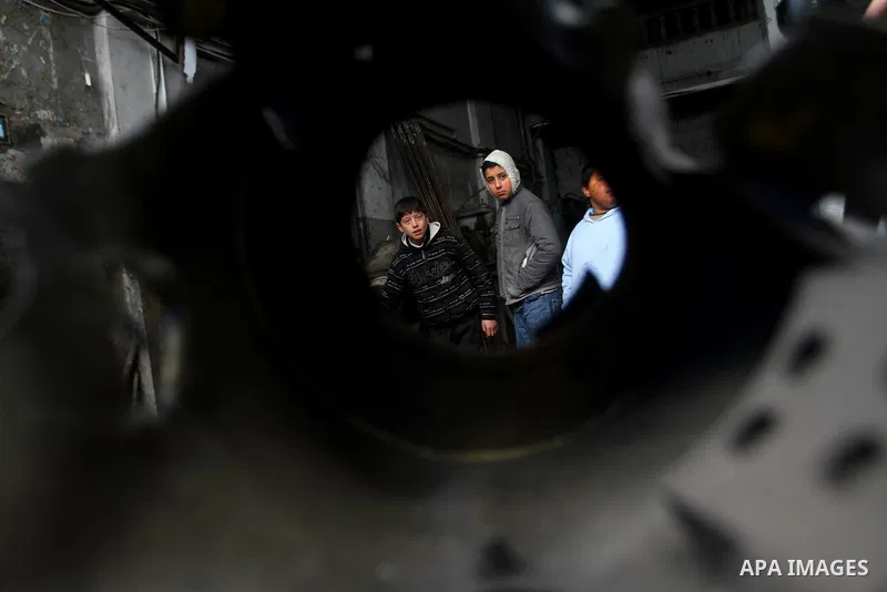 Palestinians look at what they said is a metal workshop which was damaged in an Israeli air strike on Saturday night in Gaza City February 19, 2012. Photo by Ashraf Amra