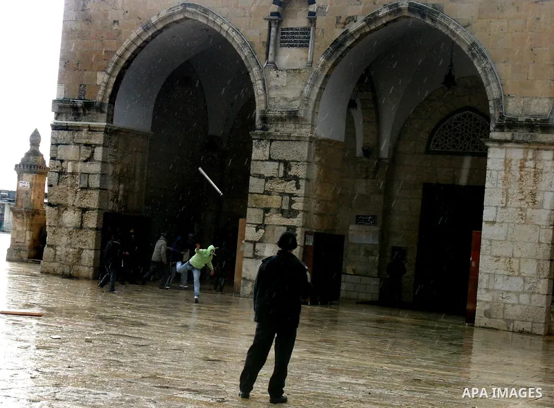 Israeli riot police at the doors to the al-Aqsa Mosque on the Hareem el-Sharif (the Noble Sanctuary), or Temple Mount, in Jerusalem, 19 February 2012, as they battle Palestinians inside during clashes. Israeli police rep...