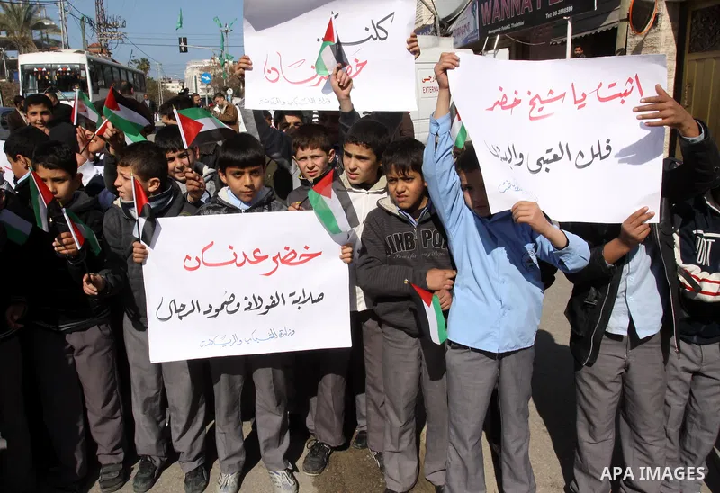 Palestinians students hold posters depicting Palestinian prisoner Khader Adnan, a member of the Islamic Jihad militant group, during a protest in front of the Red Cross in Gaza City, calling for the release of Palestinia...