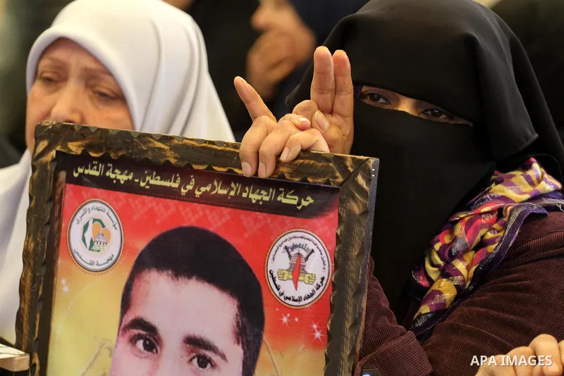 Palestinians women hold posters depicting Palestinian prisoner Khader Adnan, a member of the Islamic Jihad militant group, during a protest in front of the Red Cross in Gaza City, calling for the release of Palestinian p...