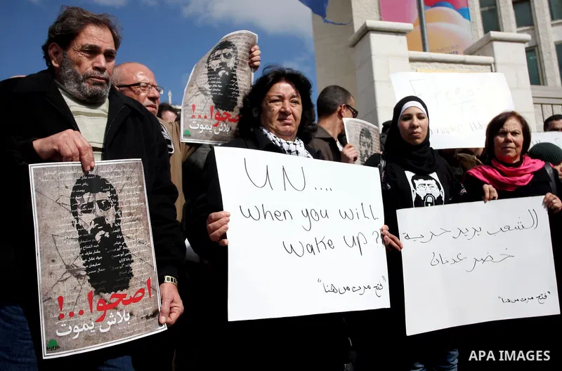 Palestinians participates in a protest in solidarity with Khader Adnan, 33, a senior member of Islamic Jihad jailed in Israel who has been on hunger strike for 65 days, and calling for the release of Palestinian prisoner...