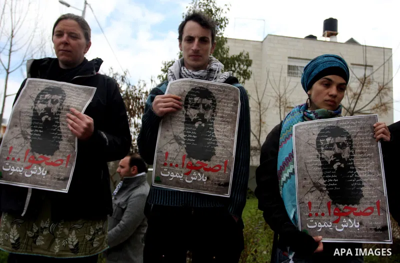 Palestinians participates in a protest in solidarity with Khader Adnan, 33, a senior member of Islamic Jihad jailed in Israel who has been on hunger strike for 65 days, and calling for the release of Palestinian prisoner...