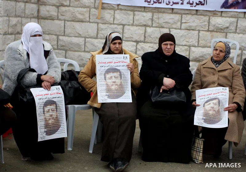 Palestinians participates in a protest in solidarity with Khader Adnan, 33, a senior member of Islamic Jihad jailed in Israel who has been on hunger strike for 65 days, and calling for the release of Palestinian prisoner...