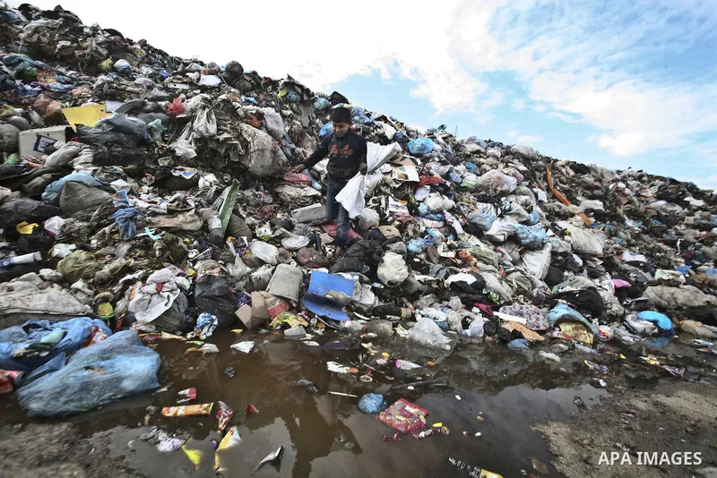 Palestinian Ahmed Mansor collects plastics and metals from a pile of waste in Jabaliya refugee camp, Gaza Strip, 19 February 2012. The United Nations Relief and Works Agency (UNRWA) states that the Israeli blockade on Ga...