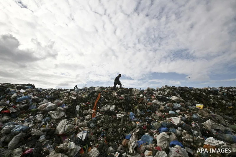 Palestinian Ahmed Mansor collects plastics and metals from a pile of waste in Jabaliya refugee camp, Gaza Strip, 19 February 2012. The United Nations Relief and Works Agency (UNRWA) states that the Israeli blockade on Ga...