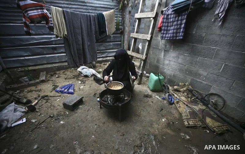 A Palestinian woman cooks inside her family home in the Jabaliya Refugee camp, Gaza Strip, 19 February 2012. The United Nations Relief and Works Agency (UNRWA) states that the Israeli blockade on Gaza has made life more...