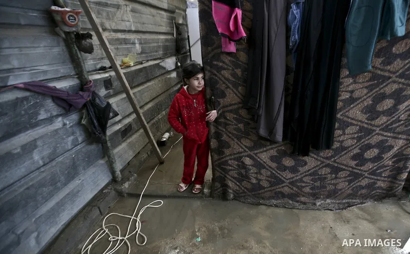 A Palestinian woman cooks inside her family home in the Jabaliya Refugee camp, Gaza Strip, 19 February 2012. The United Nations Relief and Works Agency (UNRWA) states that the Israeli blockade on Gaza has made life more...