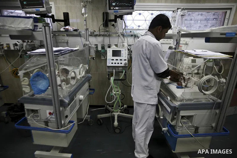 A nurse attends to a Palestinian infant in an incubator at Al-Nasser hospital in Gaza Strip on 20 February 2012. The hospital has been suffering from power cuts after the impoverished territory's sole power plant, that s...