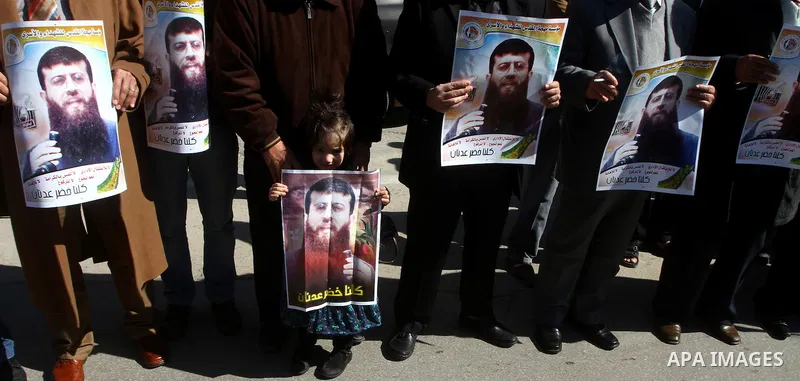 Palestinian supporters of the Islamic Jihad militant group participate in a protest in solidarity with Khader Adnan, a senior member of Islamic Jihad jailed in Israel who has been on hunger strike for 66 days, in Gaza Ci...