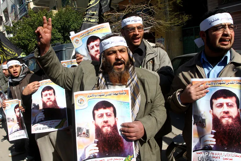 Palestinian supporters of the Islamic Jihad militant group participate in a protest in solidarity with Khader Adnan, a senior member of Islamic Jihad jailed in Israel who has been on hunger strike for 66 days, in Gaza Ci...