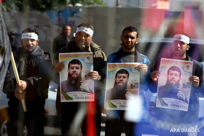 Palestinian supporters of the Islamic Jihad militant group participate in a protest in solidarity with Khader Adnan, a senior member of Islamic Jihad jailed in Israel who has been on hunger strike for 66 days, in Gaza Ci...
