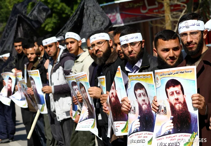 Palestinian supporters of the Islamic Jihad militant group participate in a protest in solidarity with Khader Adnan, a senior member of Islamic Jihad jailed in Israel who has been on hunger strike for 66 days, in Gaza Ci...