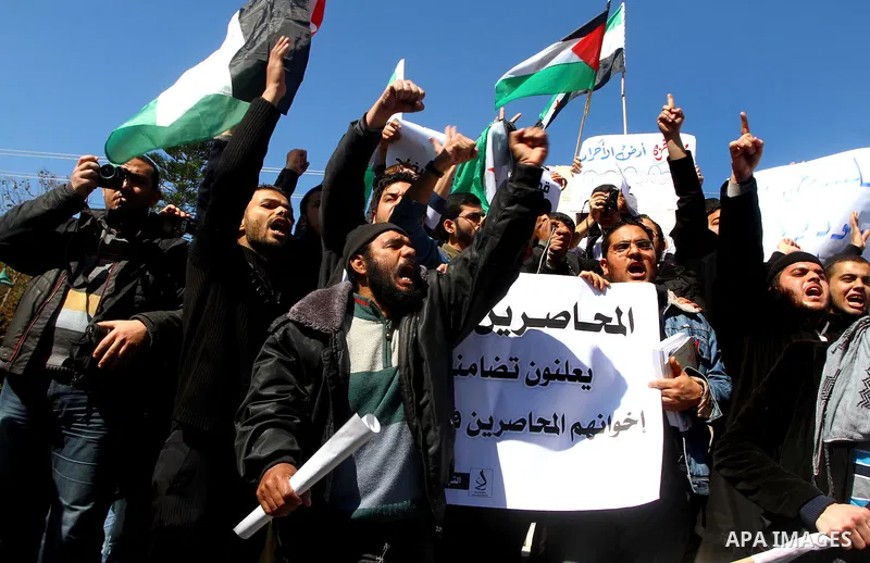 Palestinians holding Syrian flag and banners shout slogans during a protest in solidarity with Syrian people and against the Syrian government headed by president Bashar al-Asad, in Gaza city on Feb. 21,2012. Photo by As...