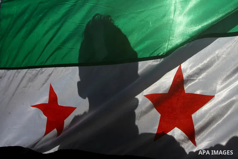Palestinians holding Syrian flag and banners shout slogans during a protest in solidarity with Syrian people and against the Syrian government headed by president Bashar al-Asad, in Gaza city on Feb. 21,2012. Photo by As...