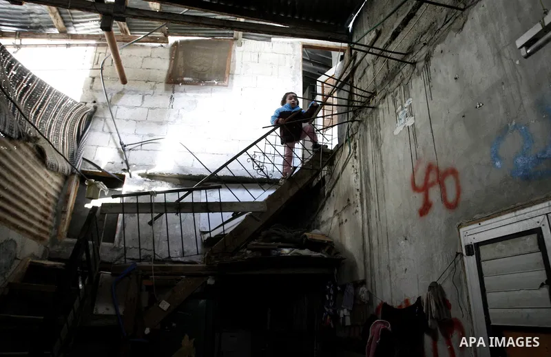 A Palestinian girl climbs the stair inside her bad-built home in Khan Younis refugee camp in southern Gaza Strip, 21 February 2012. The United Nations Relief and Works Agency (UNRWA) stated that the Israeli blockade on G...
