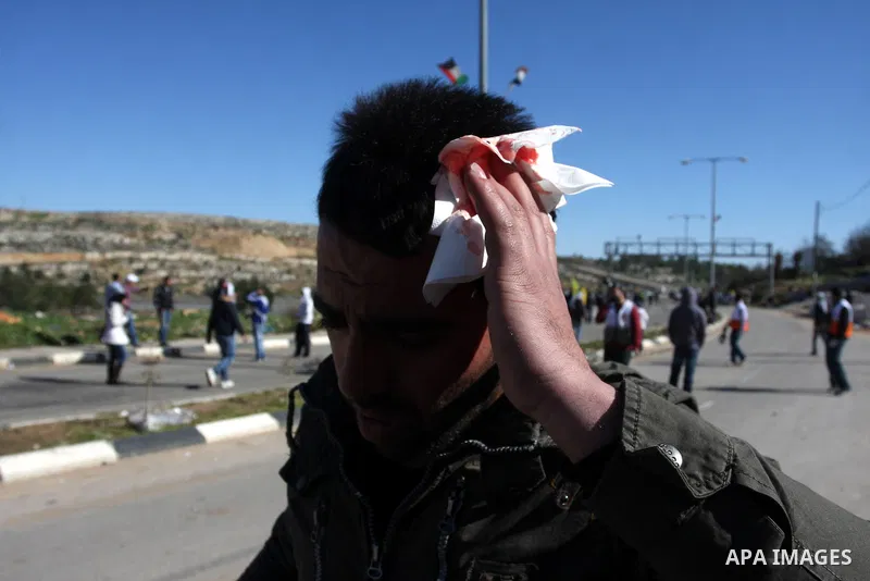A Palestinian protester throws a stone towards Israeli troops during clashes outside Ofer prison near the West Bank city of Ramallah February 21, 2012. The clashes broke out after a protest in support of Islamic Jihad me...