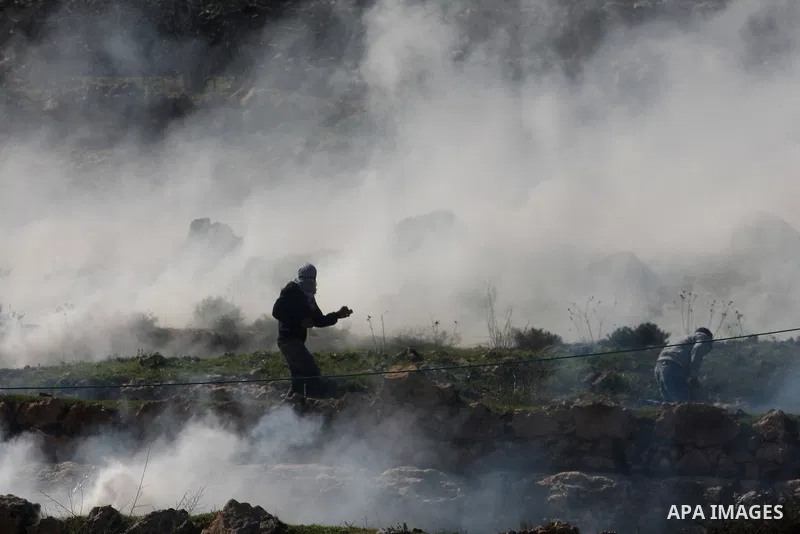 A Palestinian protester throws a stone towards Israeli troops during clashes outside Ofer prison near the West Bank city of Ramallah February 21, 2012. The clashes broke out after a protest in support of Islamic Jihad me...