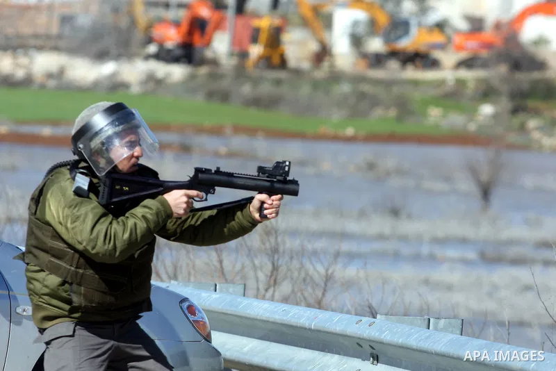 Israeli border police officers fire tear gas towards Palestinian demonstrators, during a demonstration outside the entrance of Ofer Prison near Ramallah in the occupied West Bank in support of a fellow prisoner who has e...